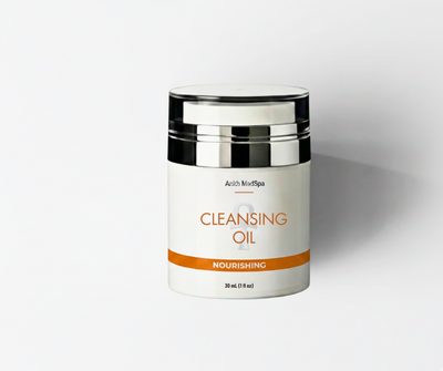 Cleansing oil container with black and silver lid on a white background