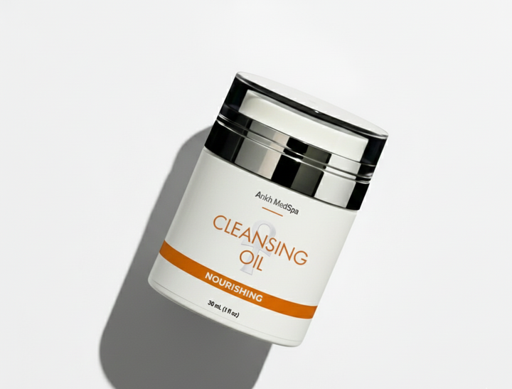 Cleansing oil container with a white label on a light gray background