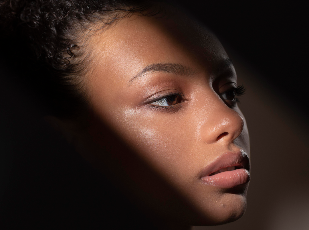 Close-up of a woman's face with a dark background