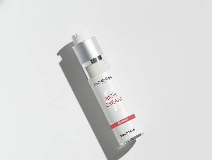 Skincare bottle labeled 'Rich Cream' on a light gray background